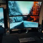 gracze korzystający z trzech monitorów podczas rozgrywki wirtualnej